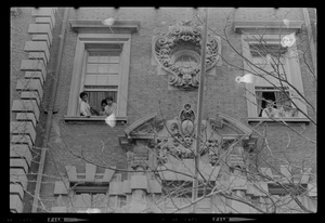 A few of the 300 students participating in the Administration Building sit-in at BU, hanging out through windows on the upper floors