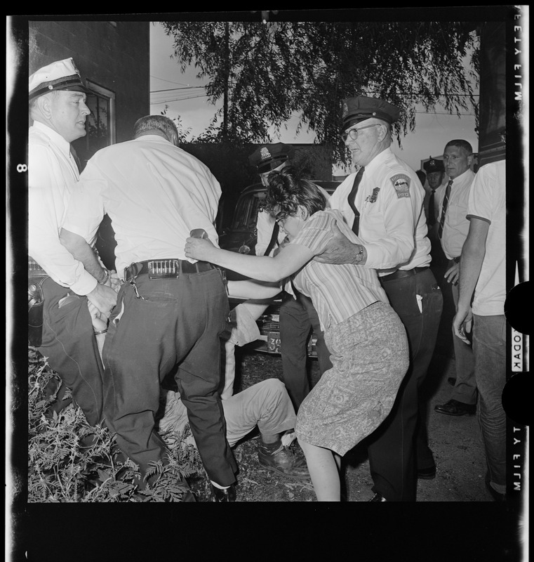 Residents in a scuffle with police officers