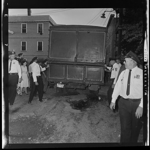 Police officers walking away from a two story truck