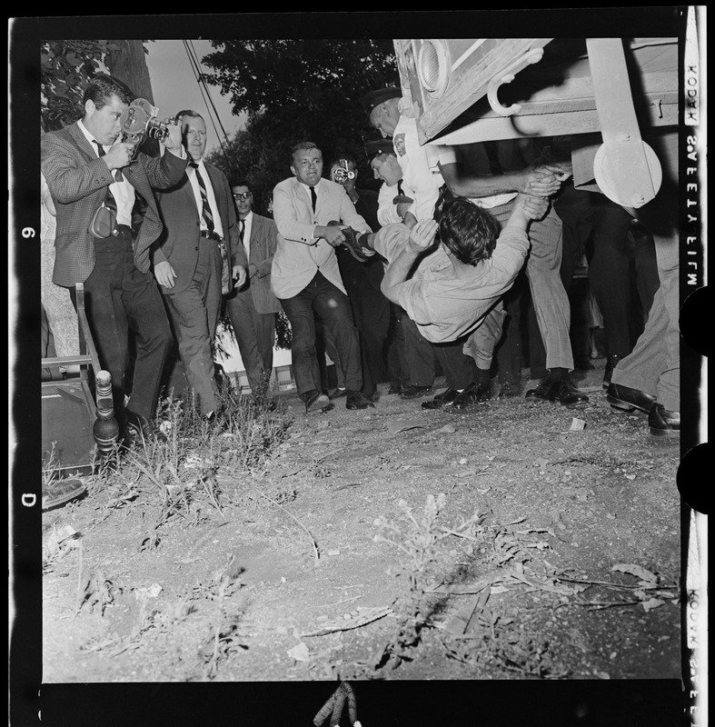 Residents in a scuffle with police officers