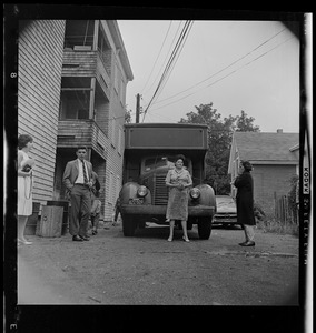 People standing in front of moving trucks