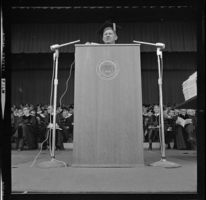 Man speaking to the crowd during commencement exercises at Brandeis University. Possibly Averell Harriman or Prof. Edwin O. Reischauer