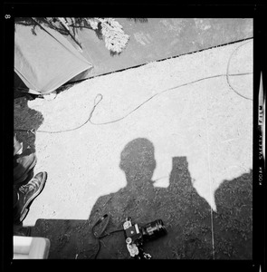 Photo of the ground featuring a shadow and camera