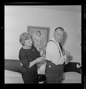 Marjorie Hall Brown adjusting her husband, Walter Brown's, suspenders