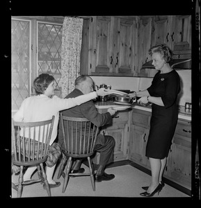 Marjorie Hall Brown serving her husband, Walter Brown, and their daughter Marjorie