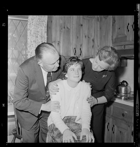 Walter and Marjorie Brown hug their seated daughter, Marjorie