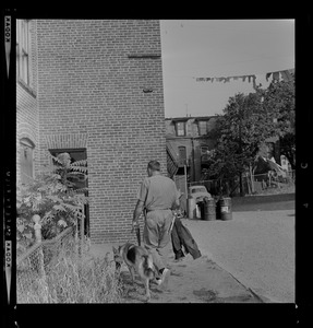 Officer with a dog walks around building