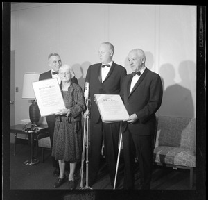 Hazel Hotchkiss Wightman and Justice G. Joseph Tauro holding Boston Medal for Distinguished Achievement awards and standing with Mayor Collins, middle, and one other man