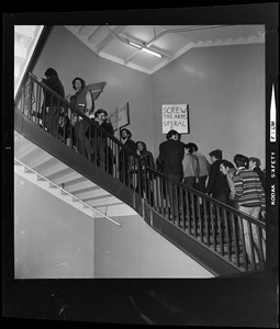 Student protesters on the stairs at MIT with signs