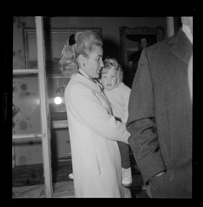 Kathryn White holding son Christopher while waiting to vote