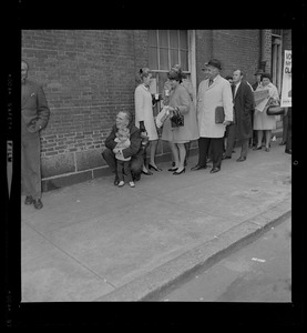 Mayor White holds his son Christopher while waiting in line to vote at the Charles Street Meeting House