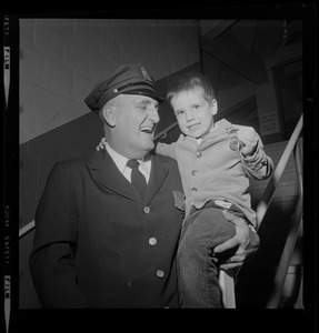 Kurt Stronach, 4, youngest child of Ptl. Clifford R. Stronach, holds up the Department Medal his father was presented last night during the Policeman's Ball