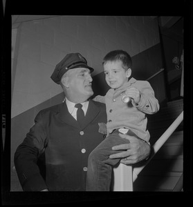 Kurt Stronach, 4, youngest child of Ptl. Clifford R. Stronach, holds up the Department Medal his father was presented last night during the Policeman's Ball