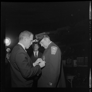 Mayor-Elect Kevin White pins the Walter Scott Medal of Honor on Ptl. Edward J. Phelan at Policemen's Ball