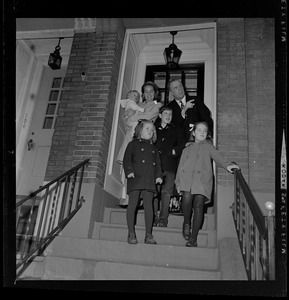 Family portrait of Kevin White, his wife, and four children on front stairs outside