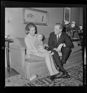 Kevin and Kathryn White sit on the couch with their youngest child Christopher on the couch