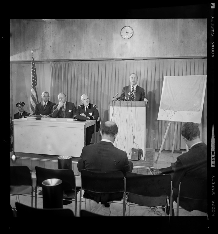 Mayor Kevin White addressing the newsmen as Boston Police officials ...