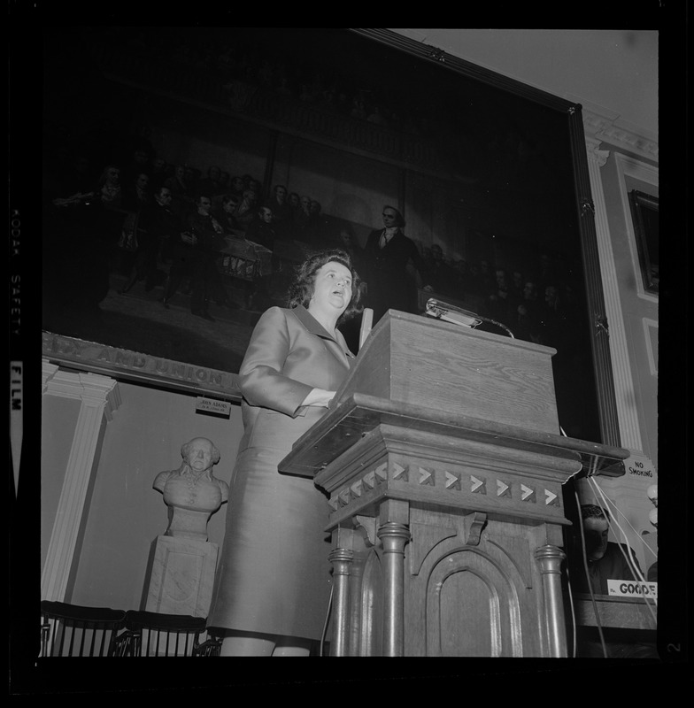 Louise Day Hicks at the podium addressing the crowd from the Great Hall at Faneuil Hall