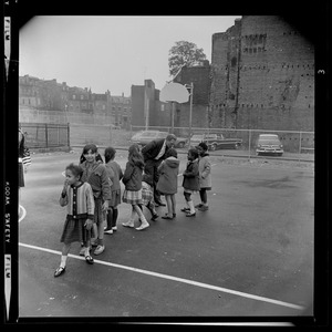 Kevin White on the basketball court with young children