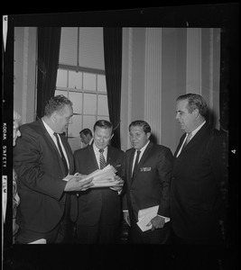 Newton Mayor Monte Basbas, left, presents to Governor Volpe a petition protesting stadium construction in Garden City as two other men look on