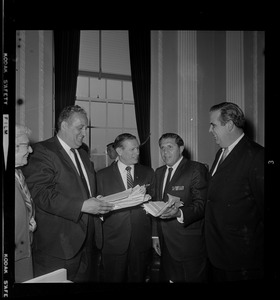 Newton Mayor Monte Basbas, left, presents to Governor Volpe a petition protesting stadium construction in Garden City as two other men look on