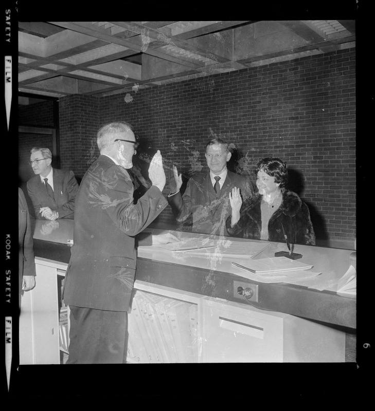 Gov. John A. Volpe and his wife Jennie Volpe taking some sort of oath at the lobby entrance of new City Hall