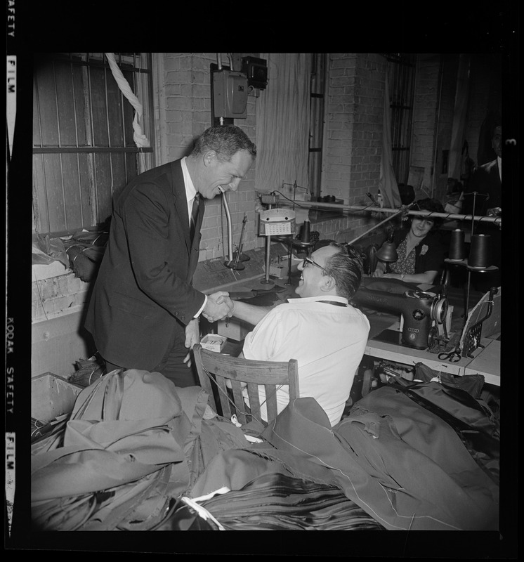 Candidate for Mayor Kevin White shakes hands with a garment worker