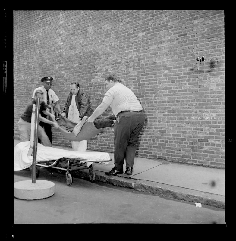 Officers placing an escaped prisoner on a stretcher, most likely Prisoner Robert Barry