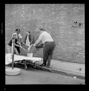 Officers placing an escaped prisoner on a stretcher, most likely Prisoner Robert Barry