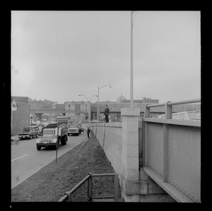 Street view with a police officers surveying along barrier wall