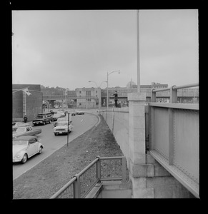 Street view with a police officer standing on top of a wall