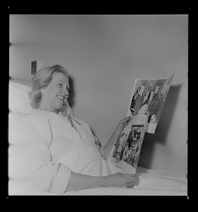 Margarita Bellotti seated and holding two photographs