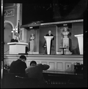Lt. Gov. Francis X. Bellotti at the podium during a debate with Rev. W. Seavey Joyce, S.J., Boston College seen on the left