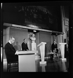 Rev. W. Seavey Joyce, S.J., Boston College, left, Lt. Gov. Francis X. Bellotti and former Gov. Volpe seen on stage during a debate