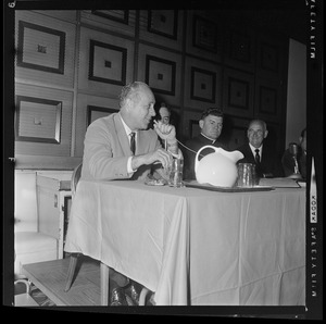 Seated, Arnold (Red) Auerbach during a press conference at Hotel Somerset about a proposed Boston stadium