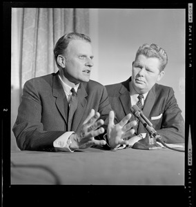 Evangelist Billy Graham and another man during a news conference