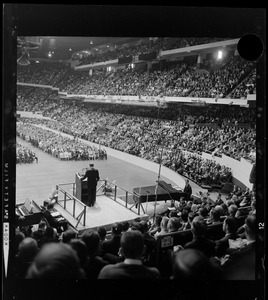 View of the crowd during evangelist Dr. Billy Graham's sermon, seen from behind the stage