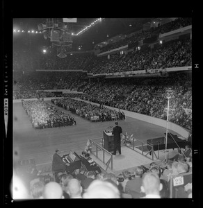 View of the crowd during evangelist Dr. Billy Graham's sermon, seen from behind the stage