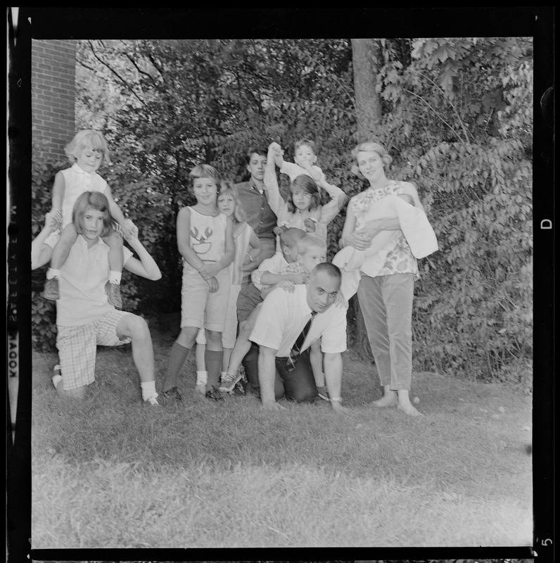 Lt. Gov. Bellotti, on all fours, with his family at home in the backyard