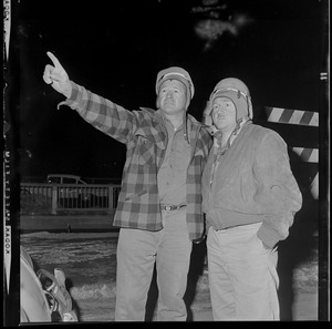Awed looking but safe, steel workers Alfred Terrence (L.) and Henri Fortin observe wreckage of Bridge where moments before they escaped death by inches