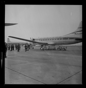 People seen descending airplane steps while greeters and press corps wait on the tarmac for their arrival