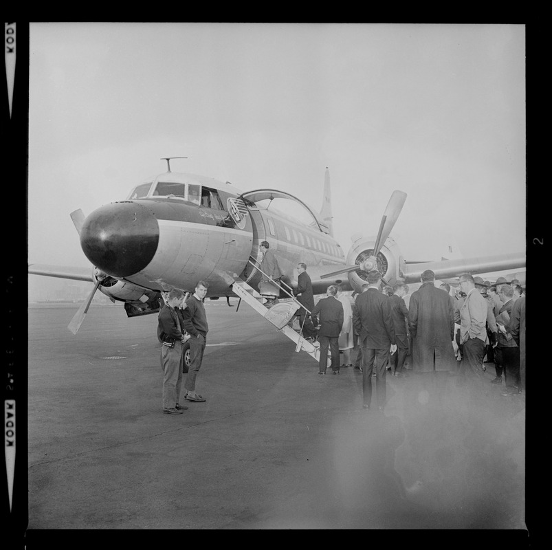 Unidentified men boarding an airplane