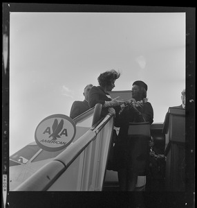 Peggy Goldwater, wife of GOP Presidential nominee, and another woman talking at the top of airplane steps