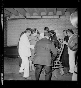 Nurses and police officers moving a patient during the blackout