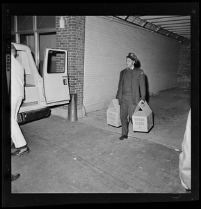 Hospital official carrying coolers of blood