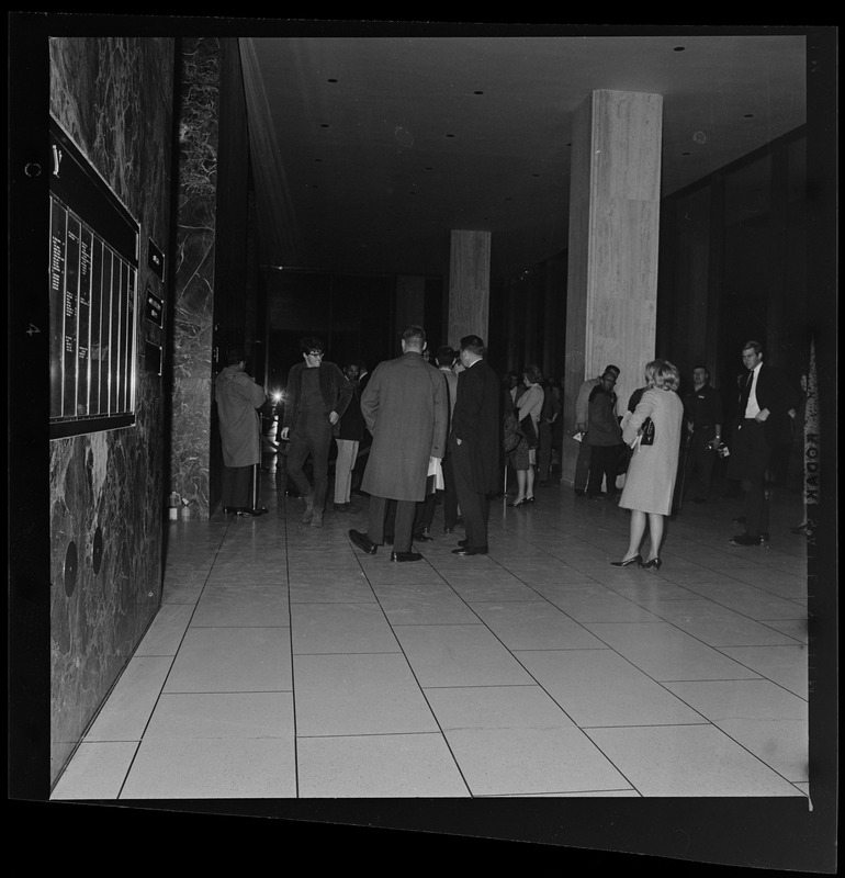 Group of people gathered in a building lobby