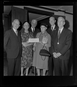 Group of people holding a sign that reads "Reserved for 1889ers"