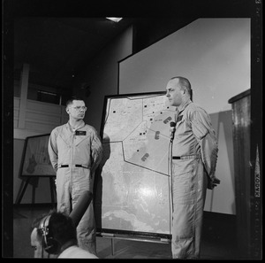 Two officers addressing an Air Force radar picket plane crash to reporters