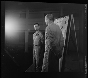 Two officers addressing an Air Force radar picket plane crash to reporters