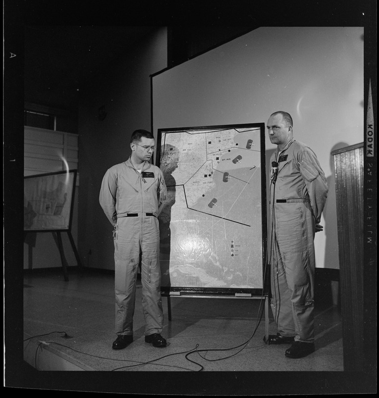 Two officers addressing an Air Force radar picket plane crash to reporters